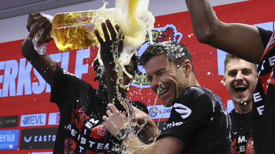 Bayer Leverkusen players pour beer on coach Xabi Alonso during a press conference after winning the Bundesliga title. Wolfgang Rattay/Reuters