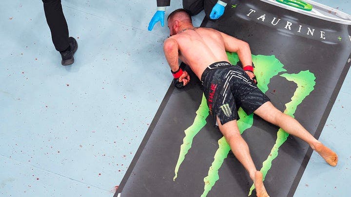 Justin Gaethje lays on the canvas in the BMF championship fight during the UFC 300 event at T-Mobile Arena on April 13, 2024, in Las Vegas, Nevada.  (Josh Hedges/Zuffa LLC via Getty Images)